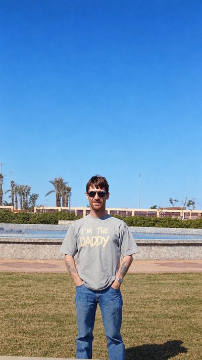 Standing outdoors in a t-shirt reading I&rsquo;m the Daddy.