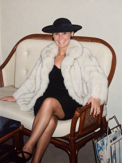 Jimi Gill&rsquo;s mother seated in a fur coat and wide black hat.